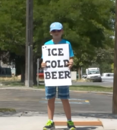 Cops Called On Boy Selling ‘Ice Cold Beer’, Burst Out Laughing When They Look Closer At Sign